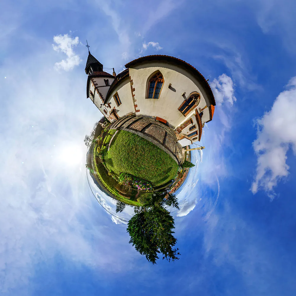 57648770 - funny street view of little french village. curvature of space, little planet effect, panoramic view.