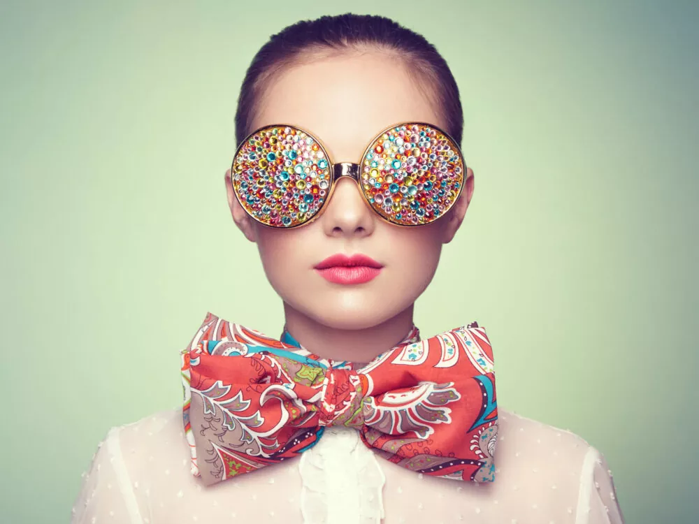 40214198 - portrait of beautiful young woman with colored glasses. beauty fashion. perfect make-up. colorful decoration. jewelry