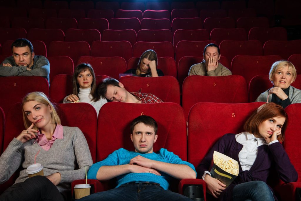 18191987 - group of boring people watching movie in cinema